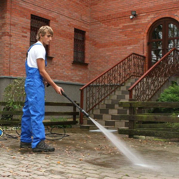 man using a pressure washer